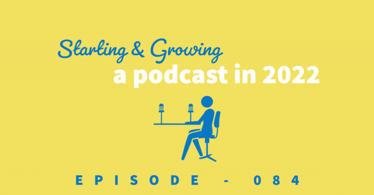 starting and growing a podcast. Podcaster sitting at a table with two podcast mics.